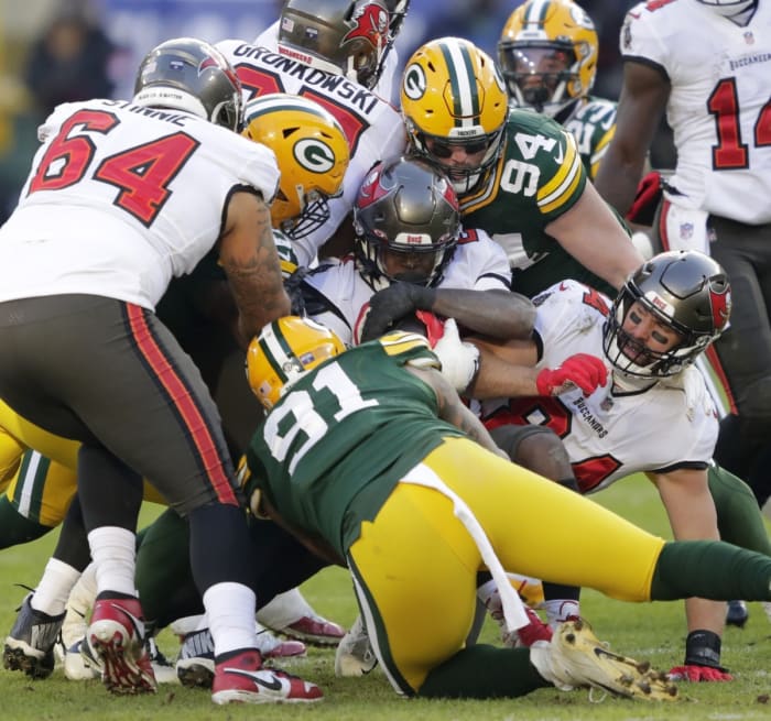 Tampa Bay running back Ronald Jones (27) is stopped by Green Bay Packers Kenny Clark during the NFC championship game. © Dan Powers/USA TODAY NETWORK-Wis via Imagn Content Services, LLC